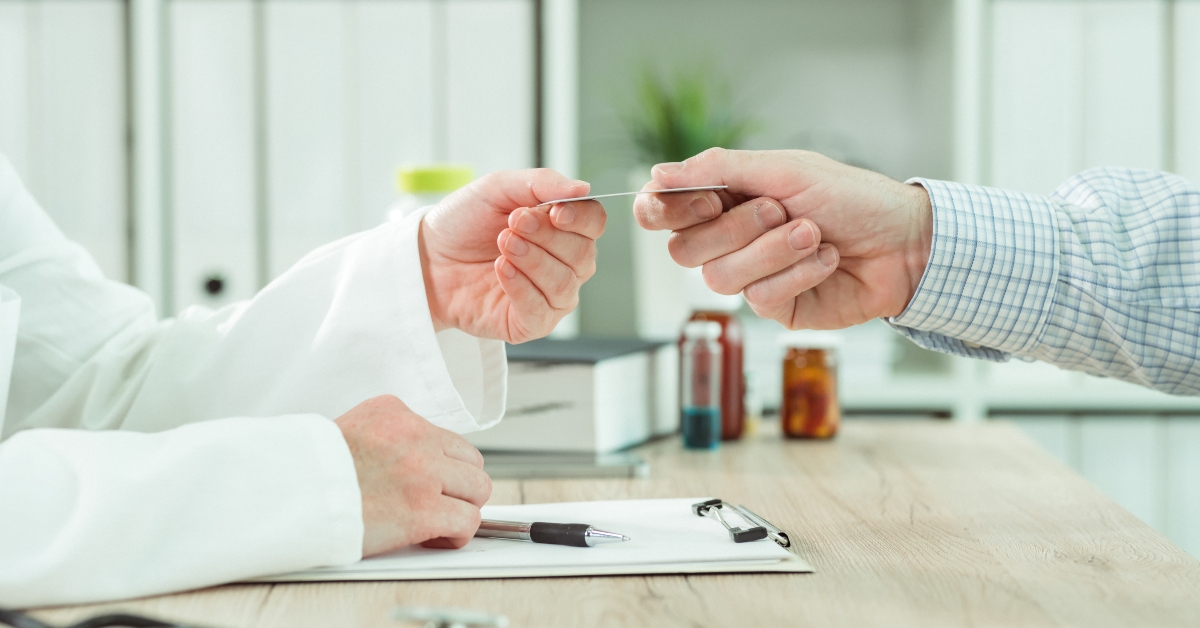 Doctor taking medical insurance card