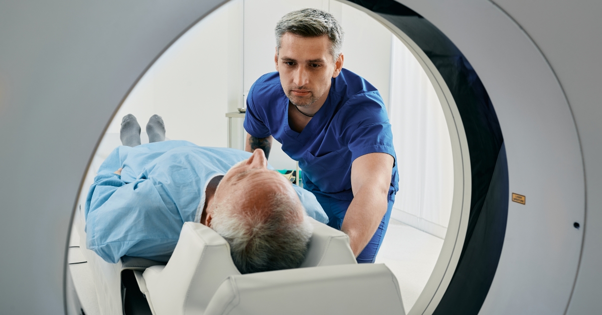 senior man going into ct scanner