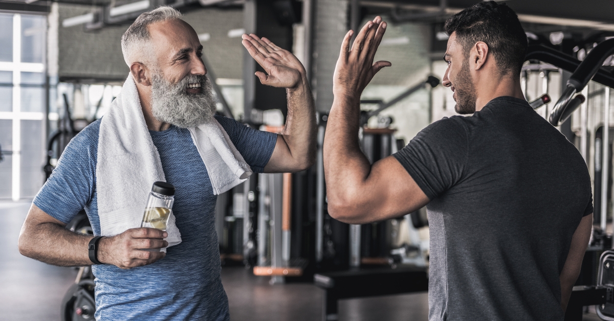males are talking to each other in modern gym