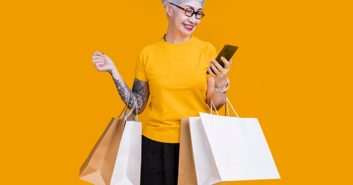 senior woman holds colourful shopping packages