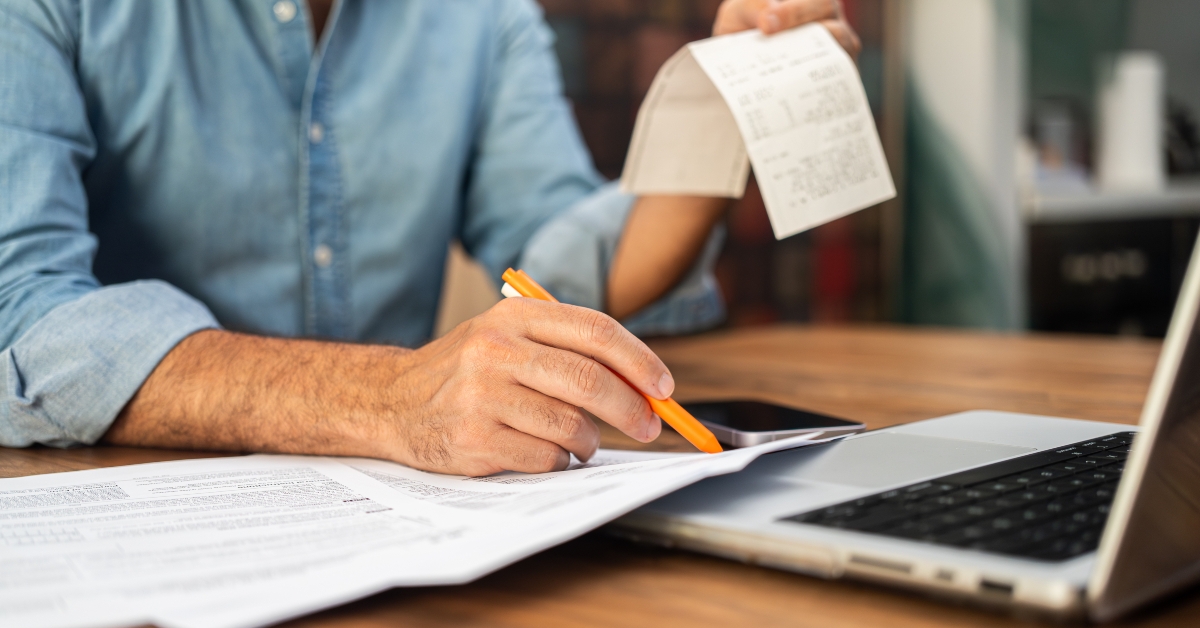 man filling out tax forms