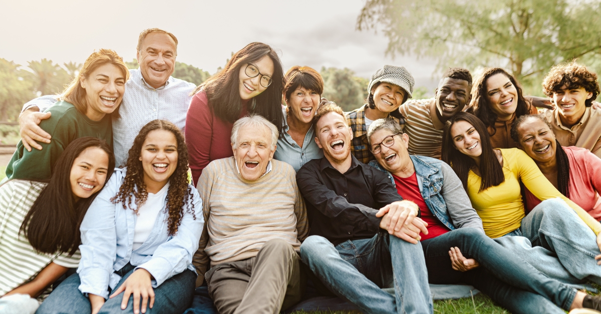 multigenerational people having fun sitting on grass