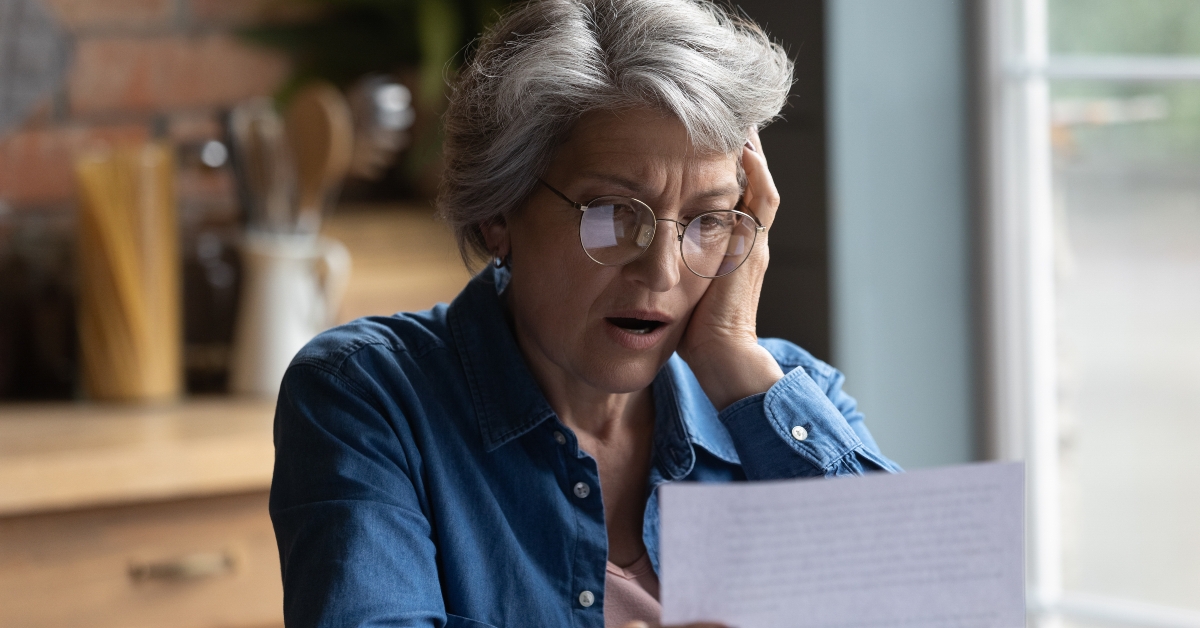 woman read post paper letter shocked by bad news