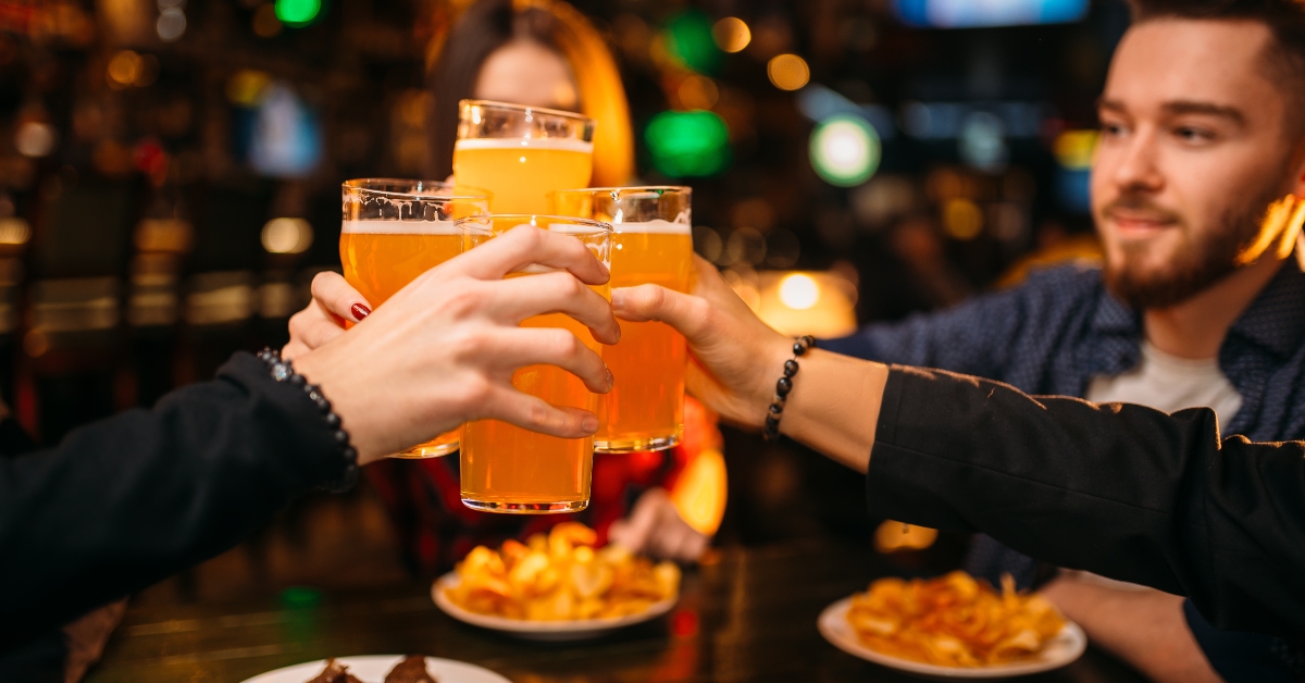 company members raised their glasses in a sport bar