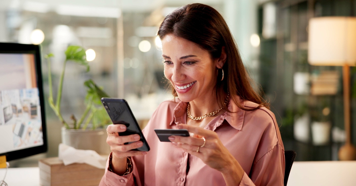 woman using phone for payment with credit card for online shopping