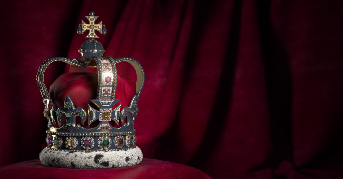 royal golden crown with jewels on pillow