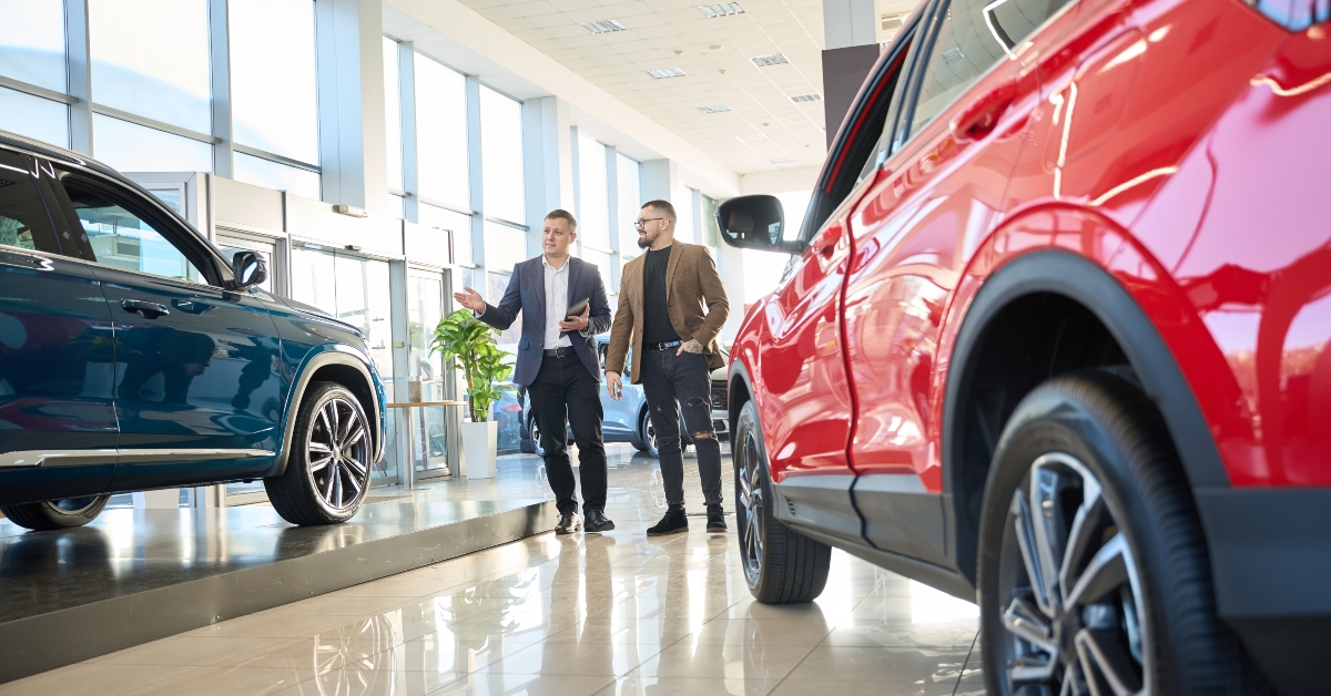 Salesman showing new cars to a buyer