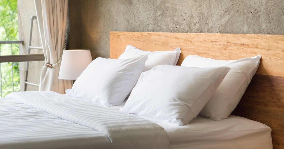 white pillows on the bed in loft style bedroom