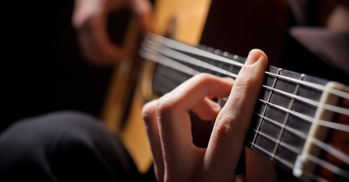 man playing acoustic guitar