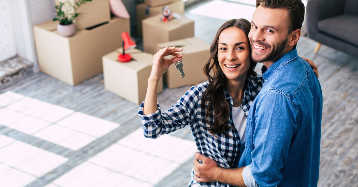 couple holds happily a key