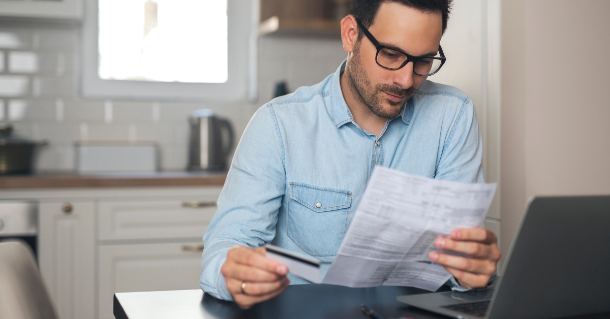 young man holding credit card 