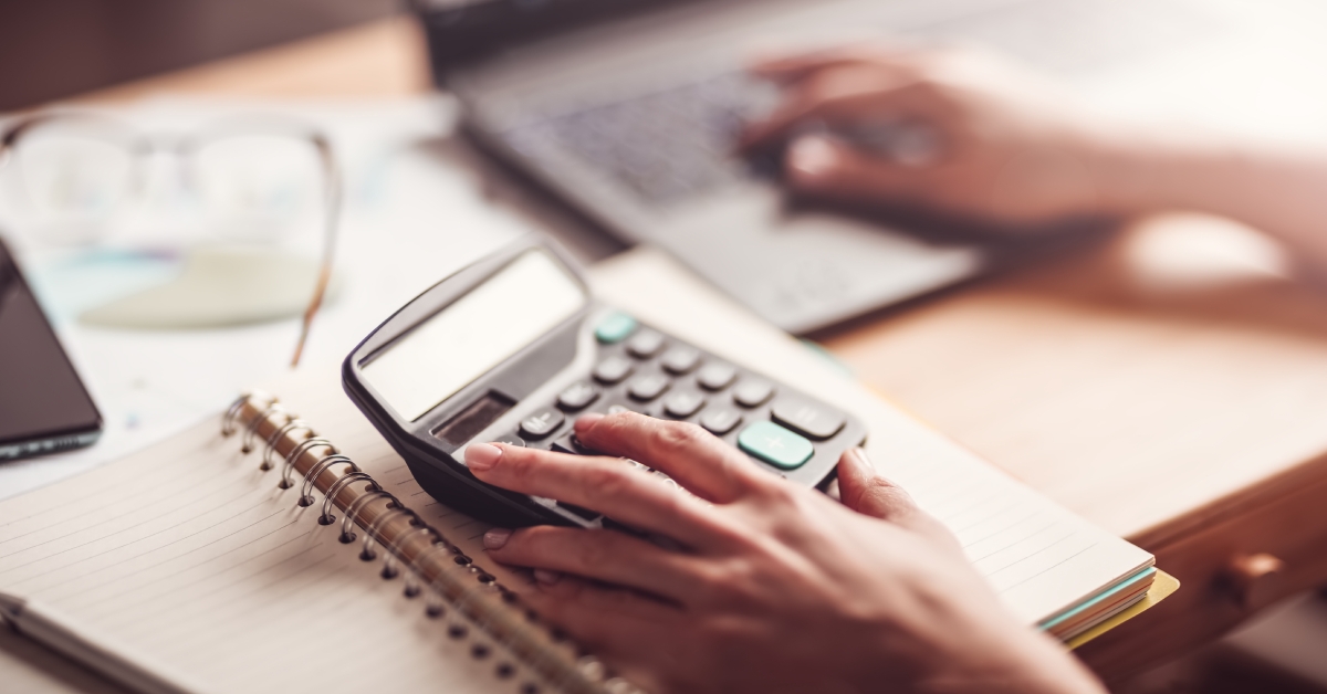 working with laptop and calculator 