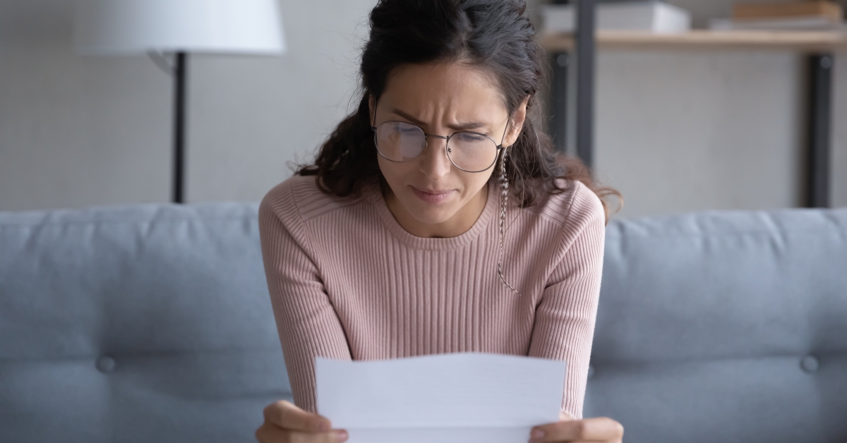 woman in glasses reads post