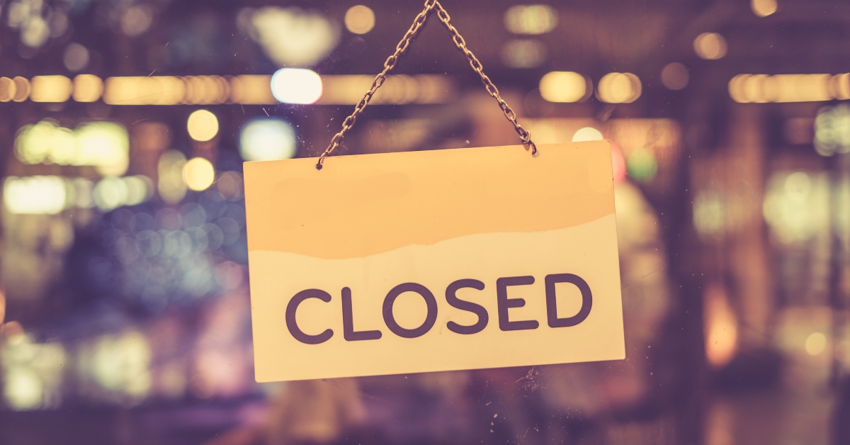 A closed sign hanging in a shop