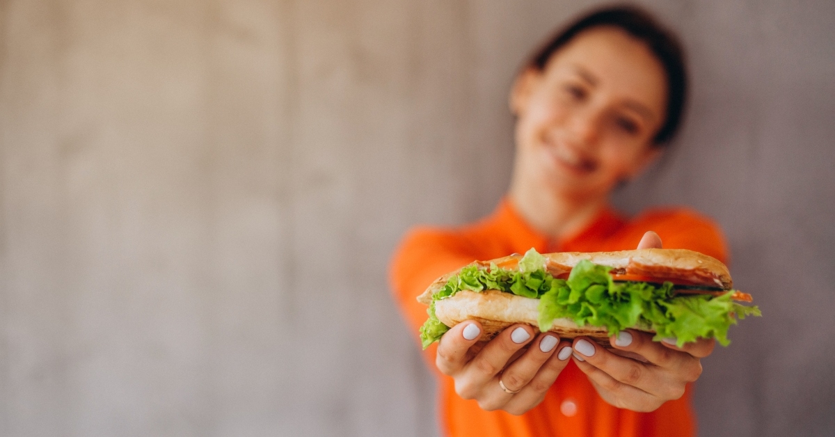 girl holds a delicious sandwich