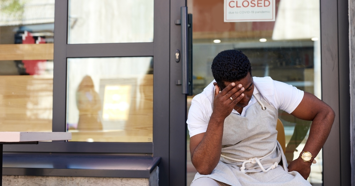 sad cafe owner sit outdoors