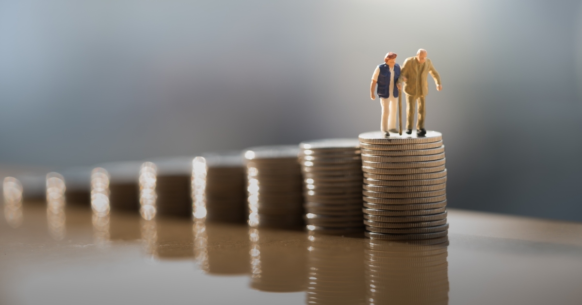 couple figure standing on top of coin stack