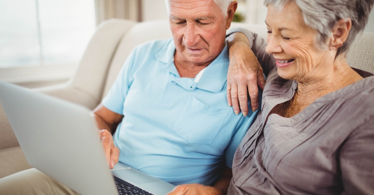 senior couple looking at laptop 