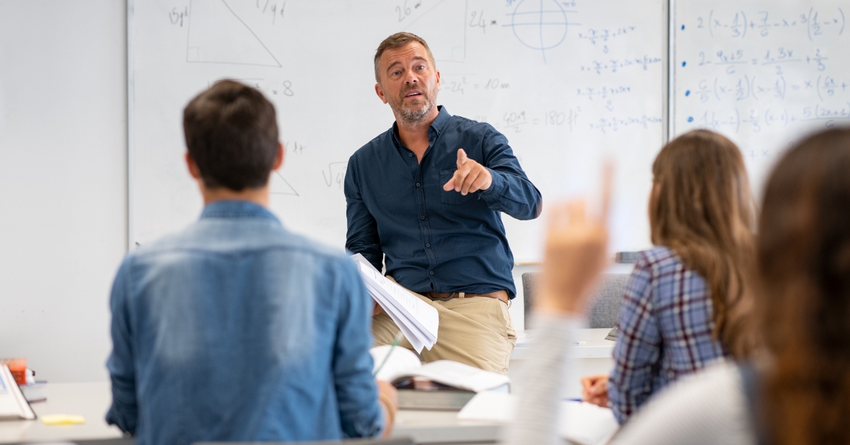 student raising hand in classroom