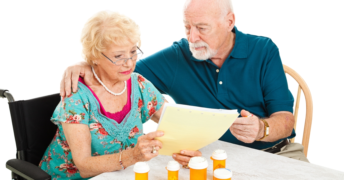 senior couple reading medical bills