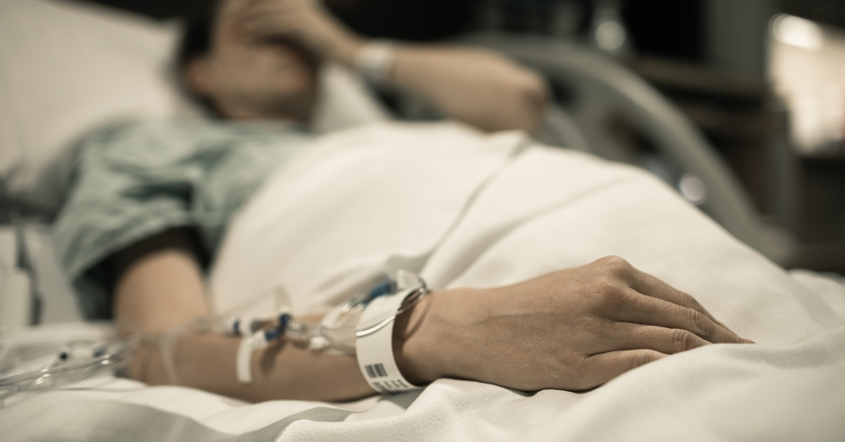 woman patient lying at hospital bed feeling sad 