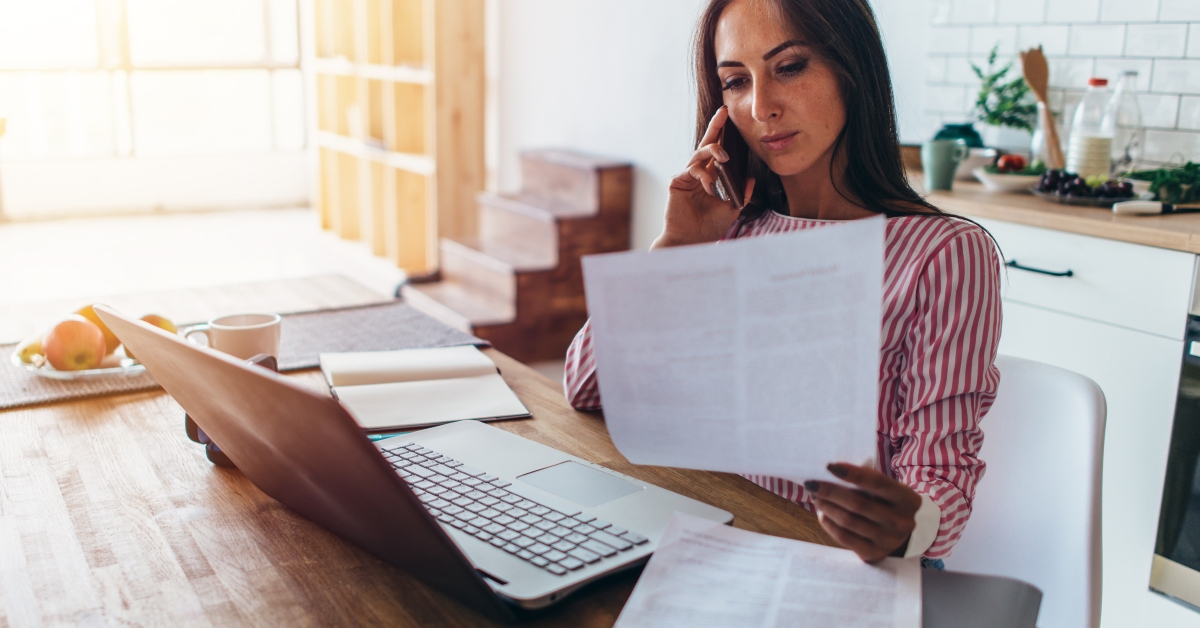 woman using laptop and talking on mobile phone