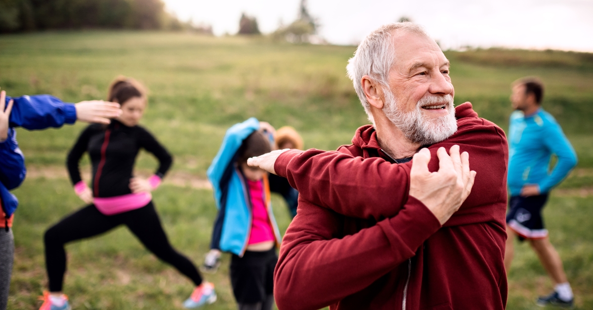 active people doing exercise in nature, stretching