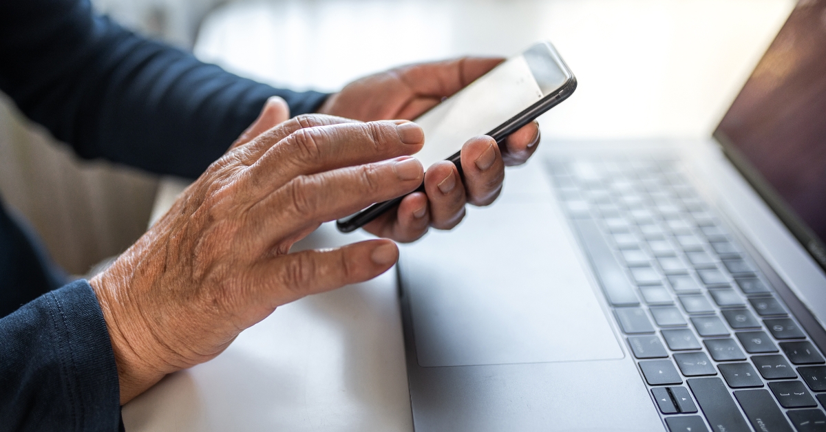 senior person using mobile phone and laptop