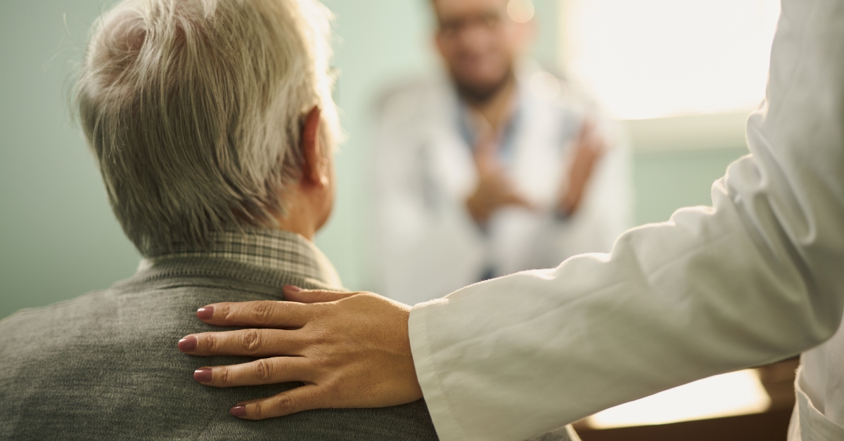 unrecognizable doctor consulting to senior patient