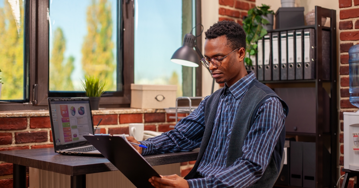 a man reviewing financial paperwork and marketing strategy ideas