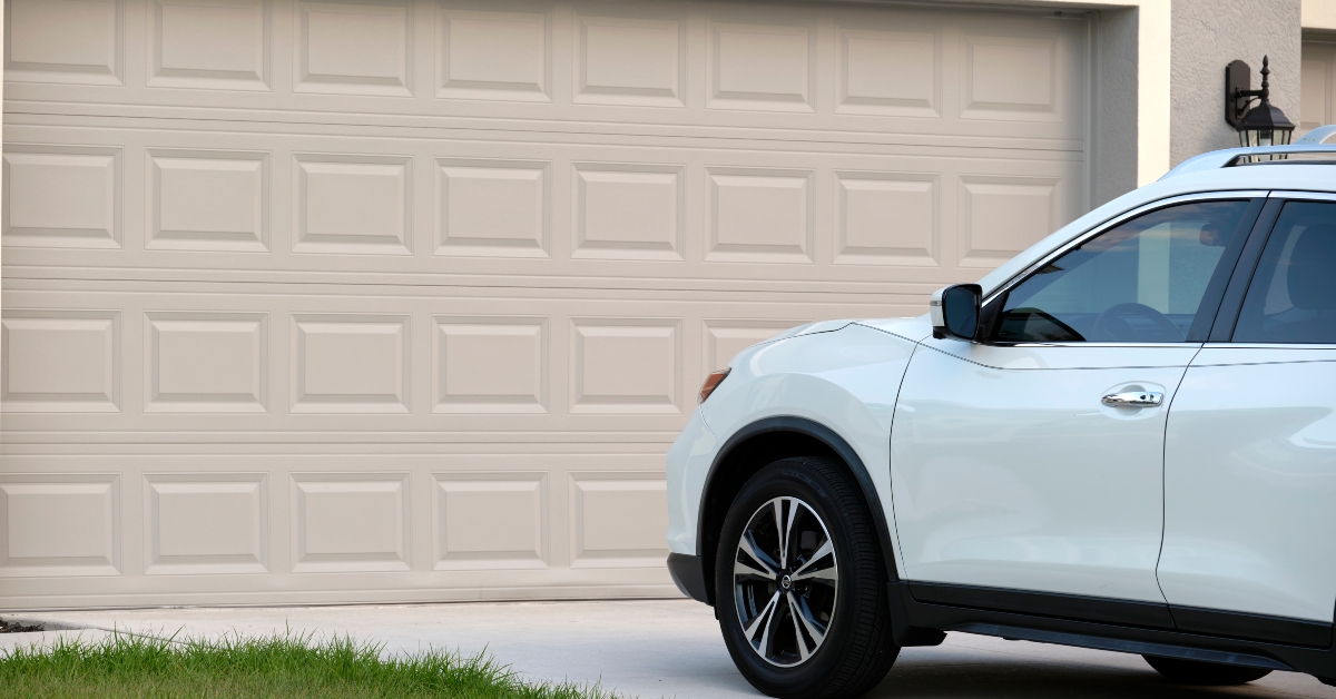 Car parked in front of wide garage