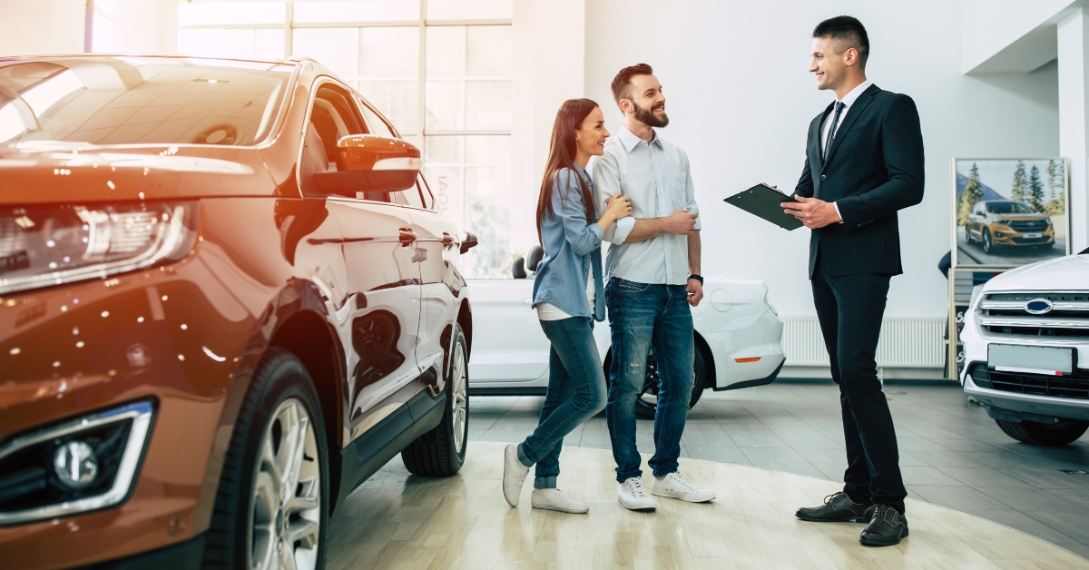 happy couple buying a new car