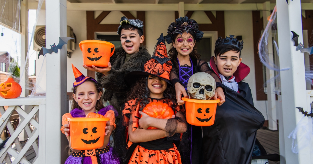 Happy multiethnic kids in halloween costumes