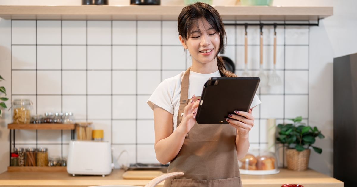 looking at a recipe on her digital tablet
