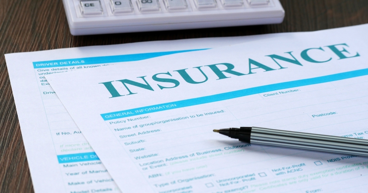 insurance form calculator and pen on the table