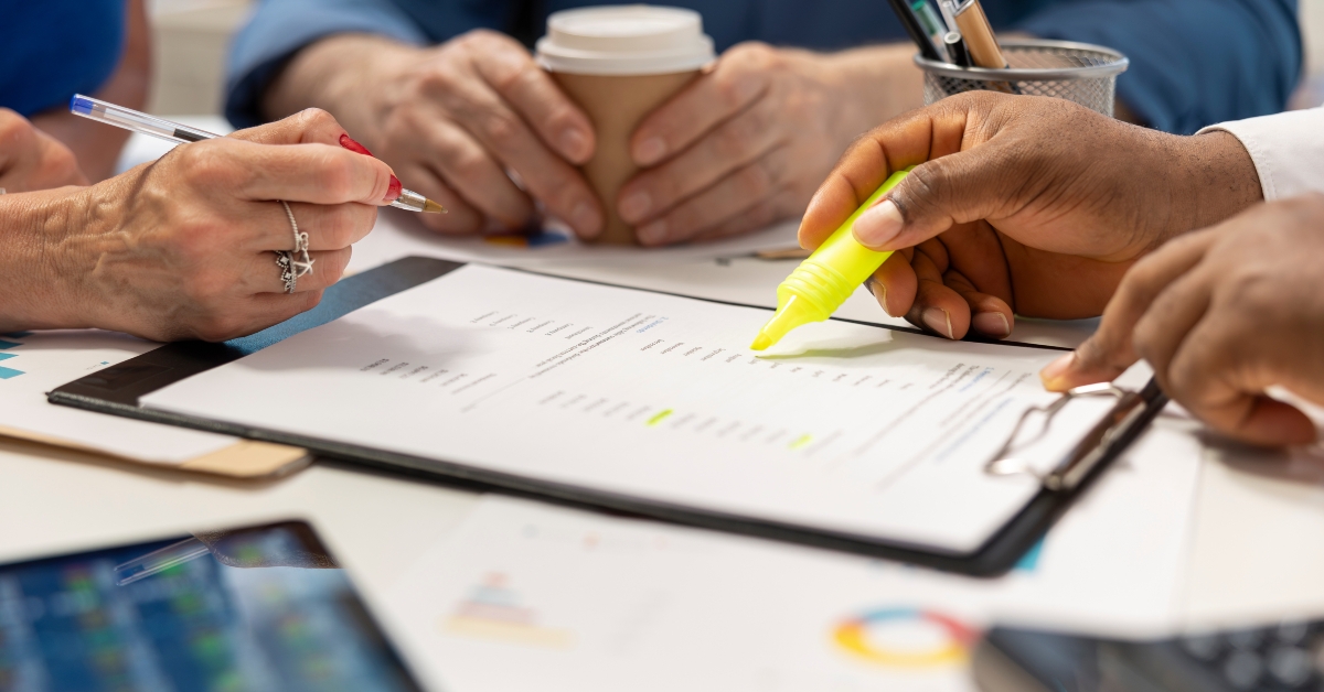 financial planner highlighting contract terms