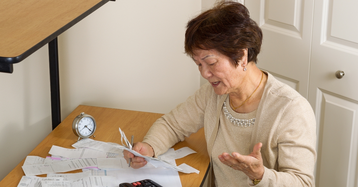 older woman frustrated by her financial bills