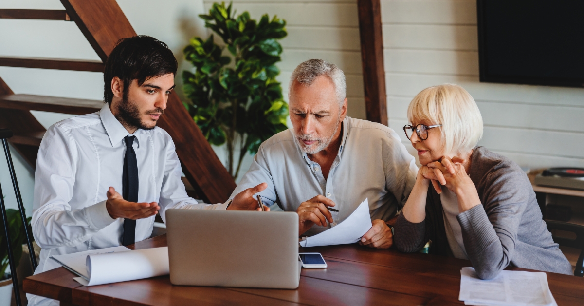 senior couple listening to the offered proposal of qualified specialist