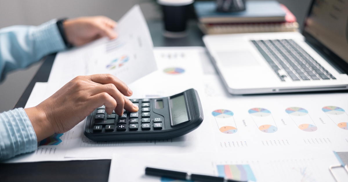 accountant writing business expense analysis saving