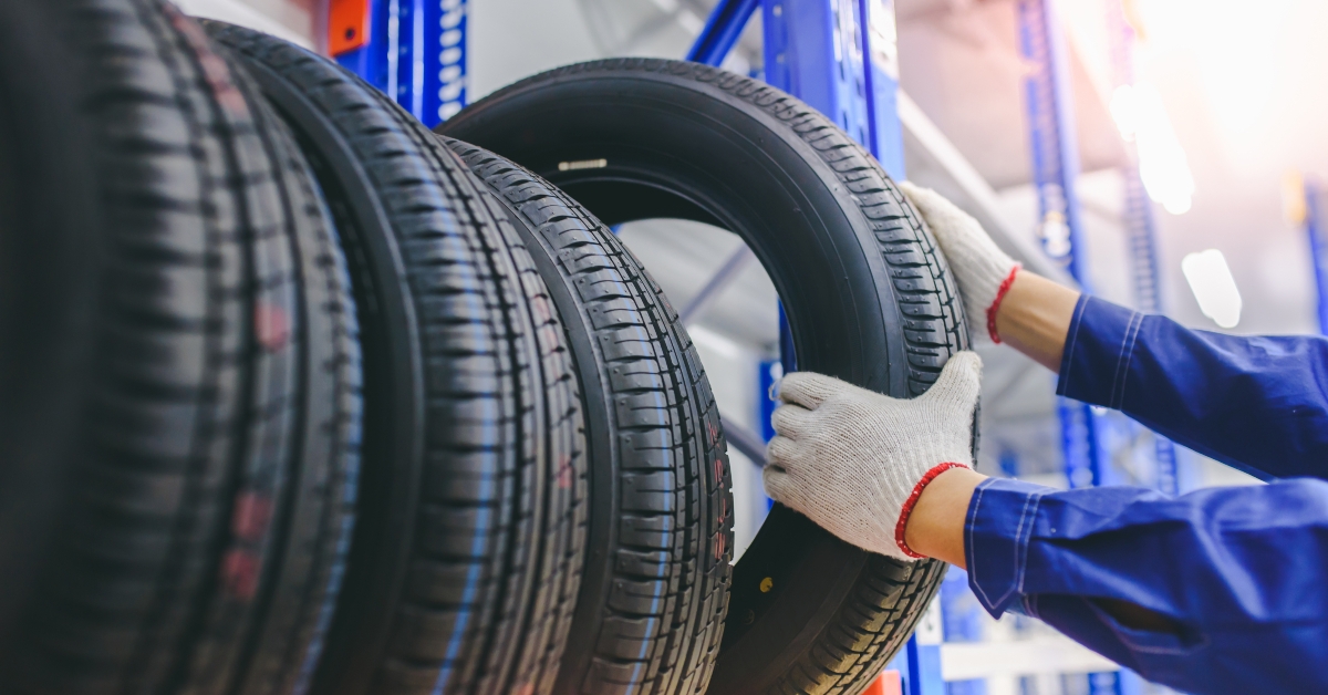 male tire changer checking the condition of new tires