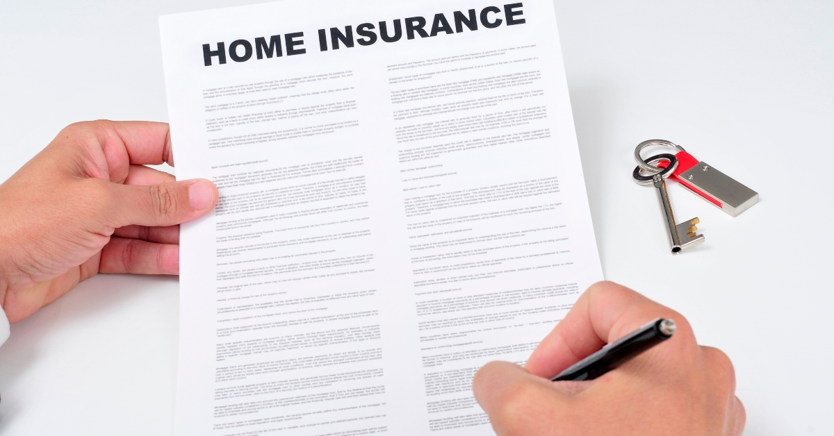 man signing a home insurance policy