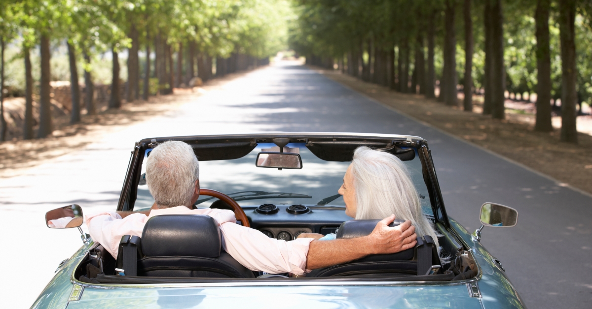 senior couple in sports car