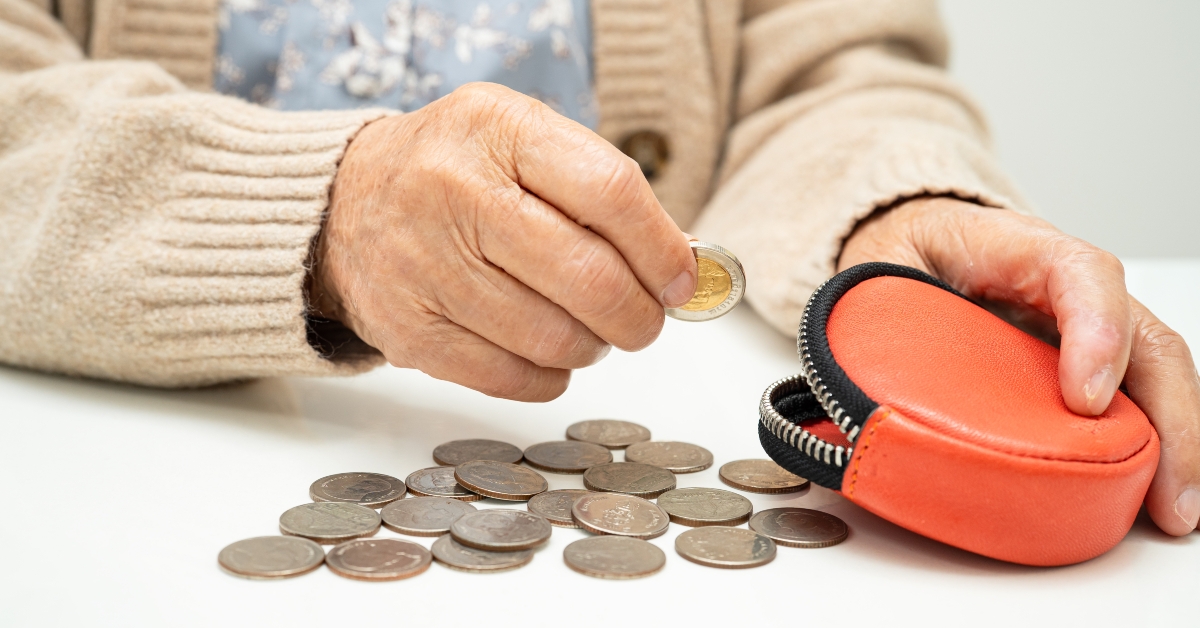 senior woman counting coin money