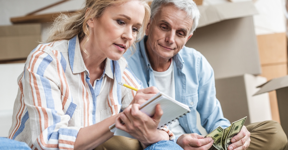 focused senior couple taking notes