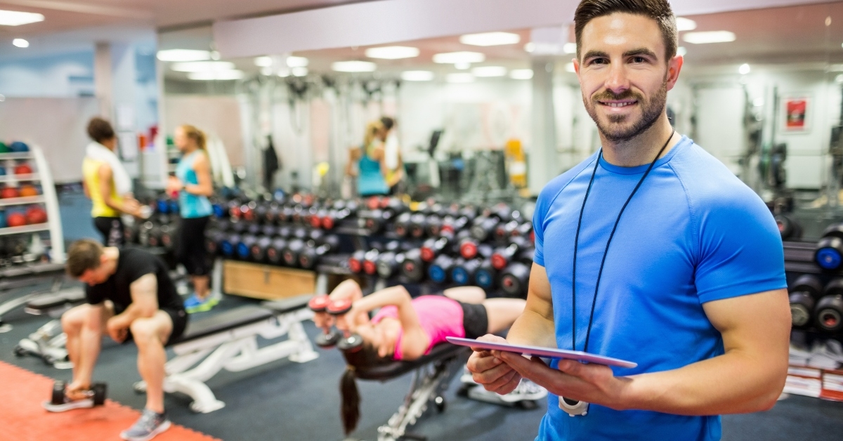 handsome trainer using tablet