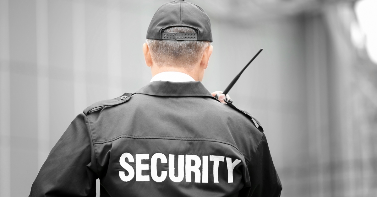male security guard using portable radio