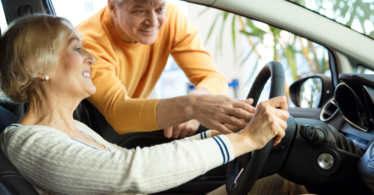 senior couple choosing a new car to buy
