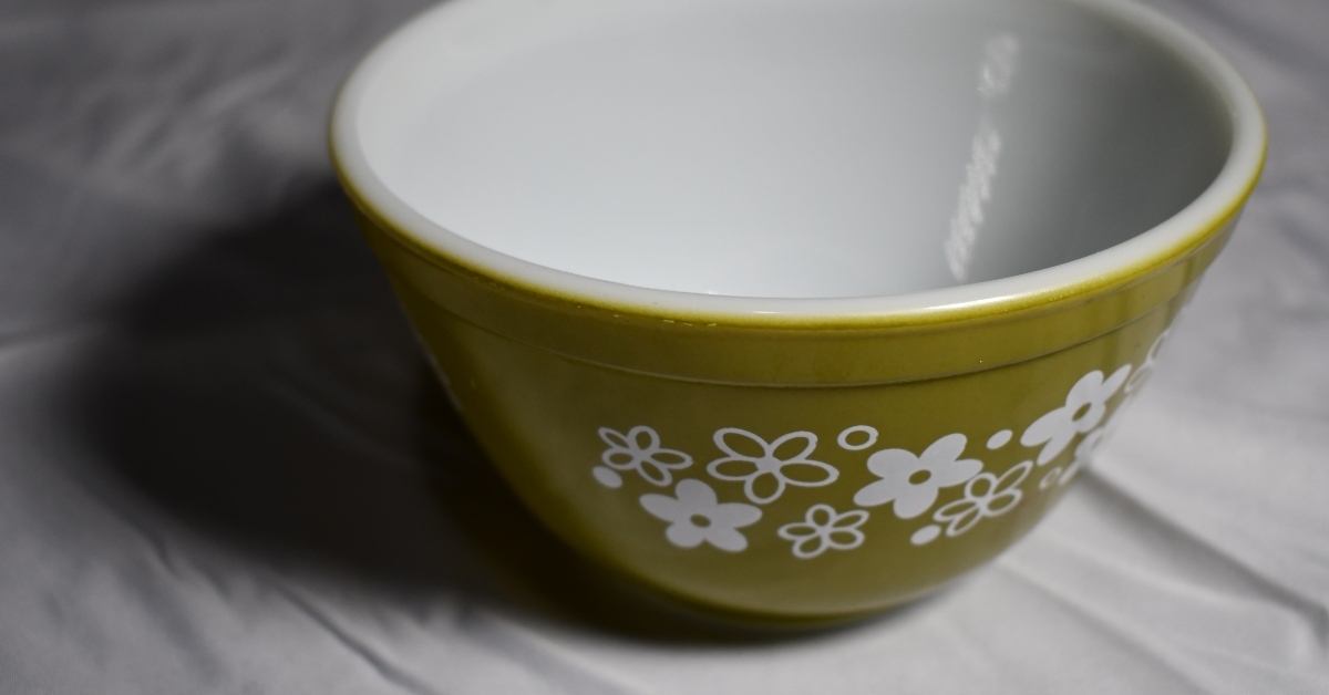 green pyrex bowl on white table cloth
