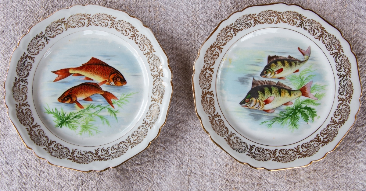 fish and scalloped rim set on linen tablecloth