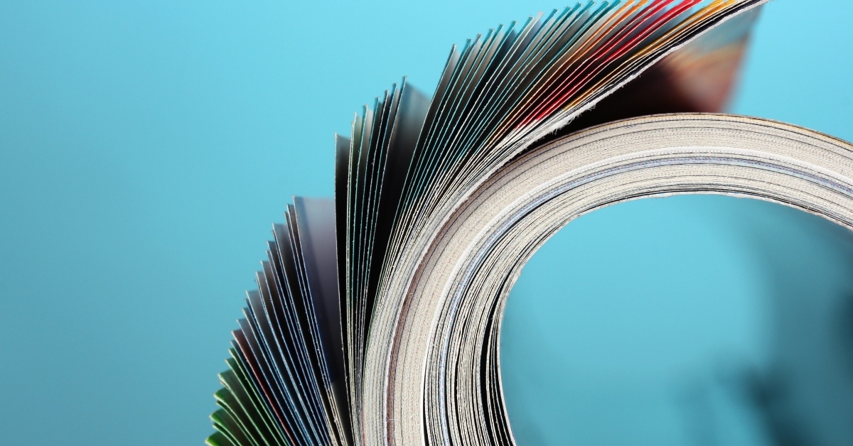 rolled up magazines on blue background